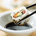 Shisu Roll being dunked in Soy